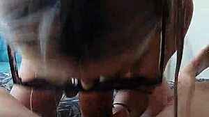 Slender girl with glasses sucks and swallows