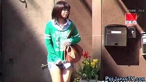 Asian babe gets wet and wild on the street